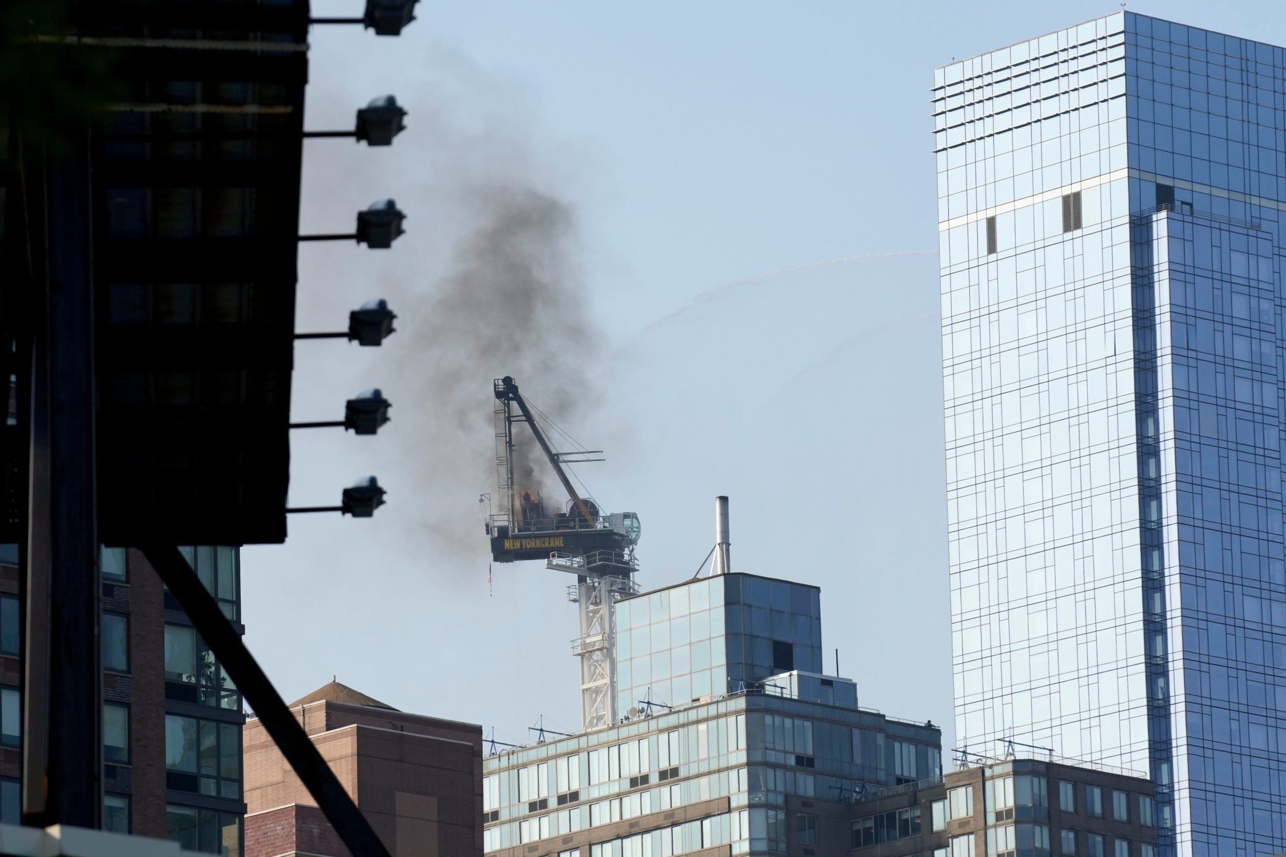 Pedestrians scatter as fire causes New York construction crane’s arm to collapse and crash to street